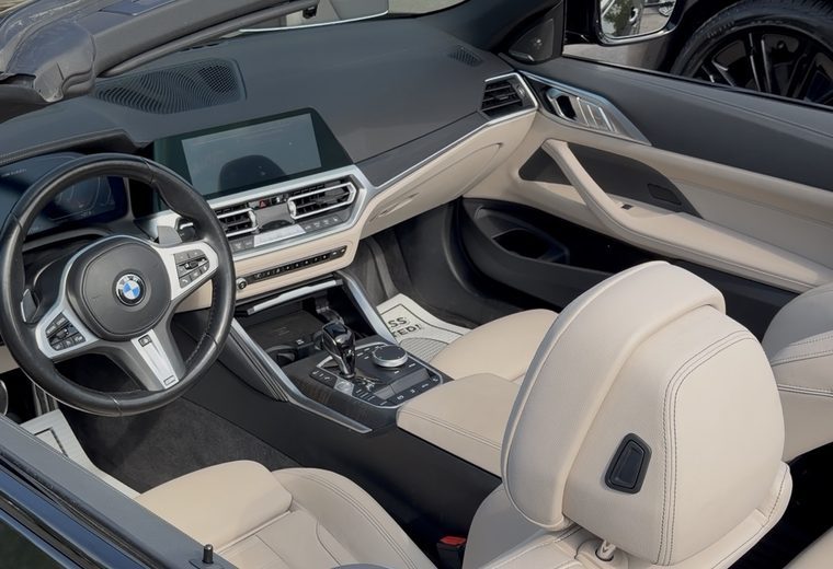 BMW 4 Series convertible cabin with cream leather and detailed dashboard